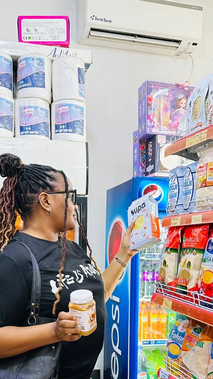 A shopper choosing Lishe360 products at a local shop